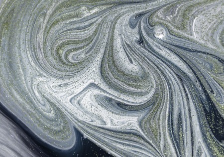Marbled abstract background with golden sequins. Liquid marble ink pattern.