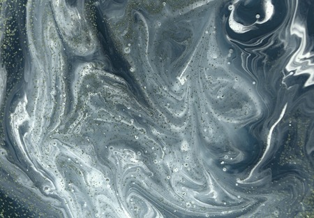 Marbled blue abstract background with golden sequins. Liquid marble ink patternの写真素材