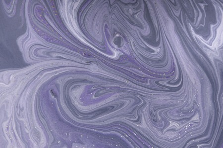 Marbled pale purple abstract background with golden sequins. Liquid marble ink pattern.の写真素材