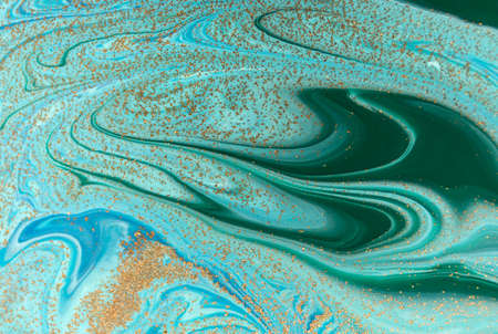 Marbled green and blue abstract background with golden sequins. Liquid marble ink pattern.の写真素材