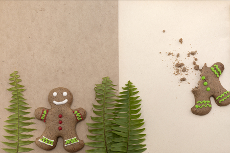 Ginger bread cookies on craft background. Blank notepad with leaf of fern. Christmas mockup. Top viewの写真素材