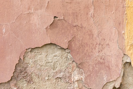 Grunge weathered texture. Close up old wall peeling plaster.