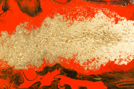 Gold marbling texture design. Red and golden marble pattern. Fluid art.の写真素材