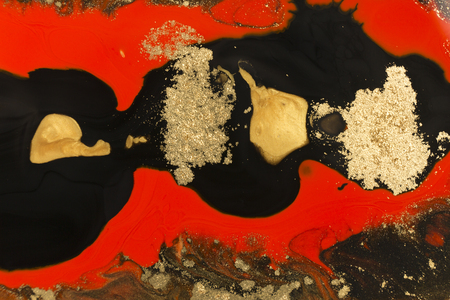 Gold marbling texture design. Red and golden marble pattern. Fluid art.の写真素材