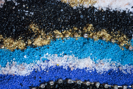 Layered colorful sand pattern. Marble style background. Blue and gold powder texture.の写真素材