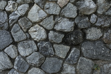 Old rough stone wall. Rock gray background.の写真素材