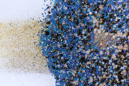 Layered colorful sand pattern. Marble style background. Blue and gold powder texture.