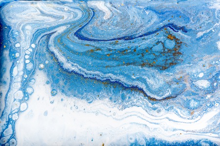 Blue and white marbling pattern with gold glitter. Marble liquid texture