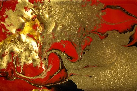 Red and gold marbling pattern. Golden marble liquid texture.の写真素材