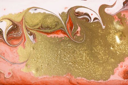 Red and gold marbling pattern. Golden marble liquid textureの写真素材