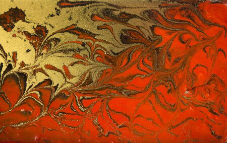 Red and gold marbling pattern. Golden marble liquid textureの写真素材