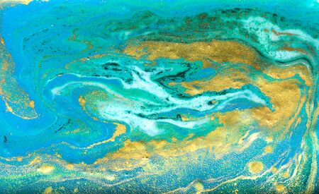 Blue, green and gold marbling pattern. Golden powder marble liquid texture.の写真素材