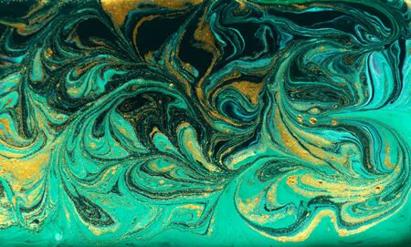 Green and gold marbling pattern. Golden powder marble liquid texture.の写真素材