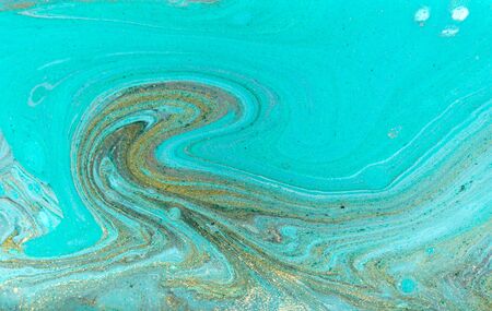 Beautiful simple light blue marble background with layers of gold glitter.