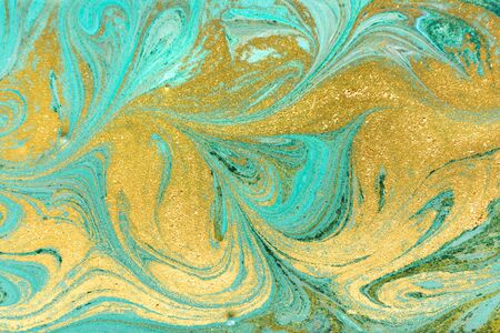 Beautiful gold and turquoise acrylic marble background.の写真素材