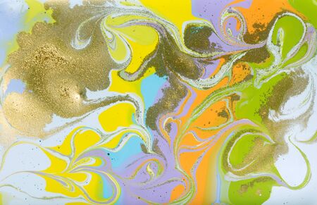 Colorful pastel marble pattern with golden glitter. Abstract liquid background