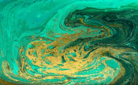 Green and gold ripple of agate background. Golden powder marble texture.の写真素材