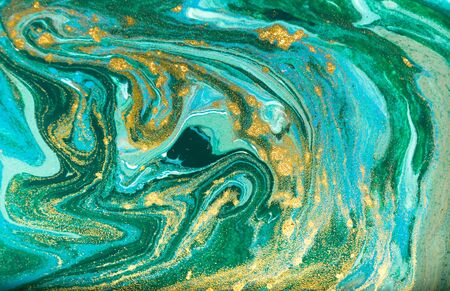 Blue, green and gold glitter pattern. Golden powder liquid texture.の写真素材