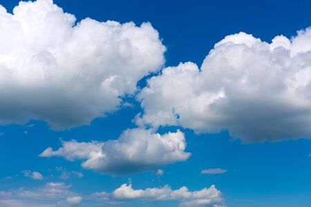 White clouds on blue sky background.