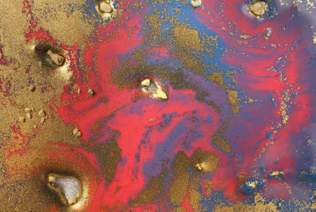 Piles of gold sequins on pink smudges of paint. Abstract pattern.