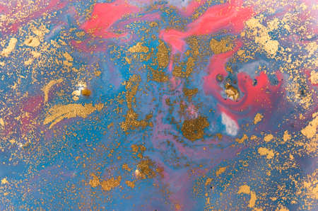 Marbled blue and pink abstract background with golden glitter.