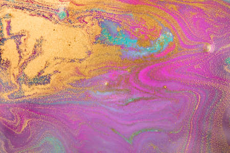 Blue and pink bright wave pattern with layers of gold sequins.の写真素材