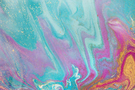 Blue and pink bright wave pattern with layers of gold sequins.の写真素材