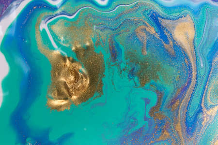 Blue wave pattern with layers of gold sequins.の写真素材