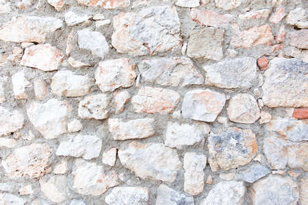 Antique stone wall. Old gray bricks background.の写真素材