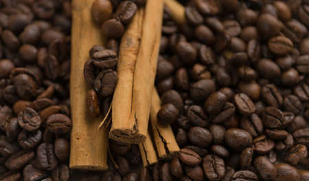 Cinnamon sticks on coffee beans blur background. Close up.の写真素材