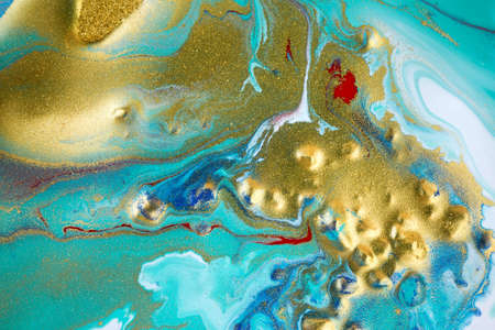 Marble blue abstract background with gold glitter. Liquid close up ink pattern.