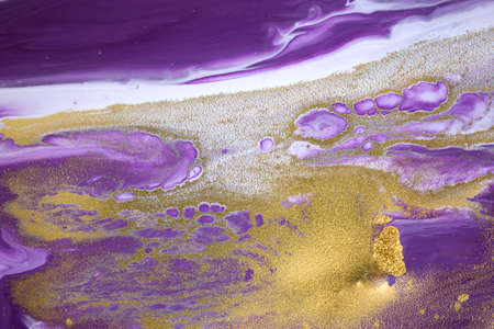Cose up gold powder on purple and white inks background.の写真素材