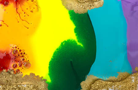 Rainbow liquid acrylic mixed ink texture with gold dustの写真素材