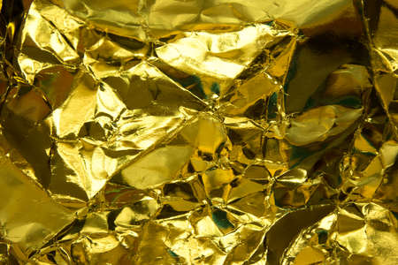 Crumpled yellow gold paper texture.の写真素材