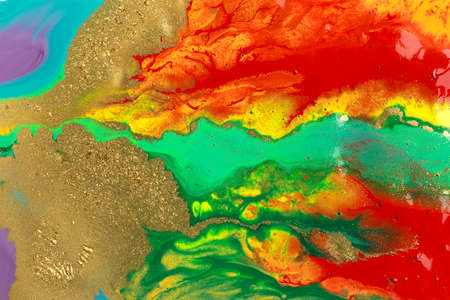 Gold spots on rainbow smudges of paint. Abstract pattern.