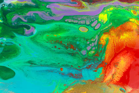 Gold spots on rainbow smudges of paint. Abstract pattern.の写真素材