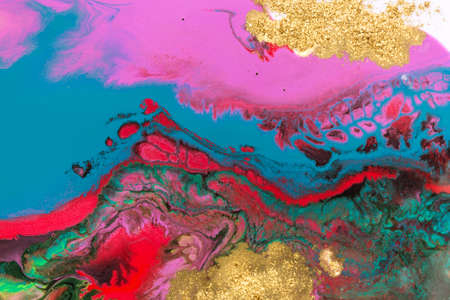 Abstract fluorescent ink liquid mix with gold dust.