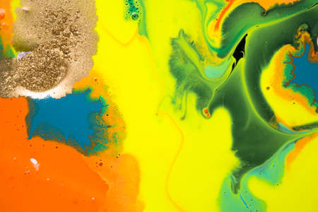 Gold spot on flow vivid paints background. Abstract print