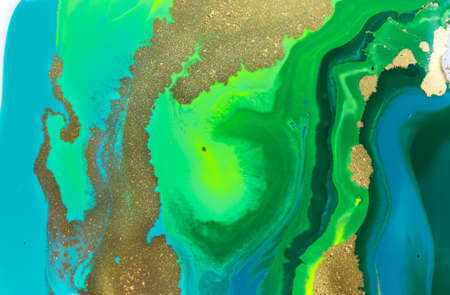 Gold spots on flow vivid paints background. Abstract printの写真素材