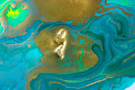 Gold spots on flow vivid paints background. Abstract printの写真素材