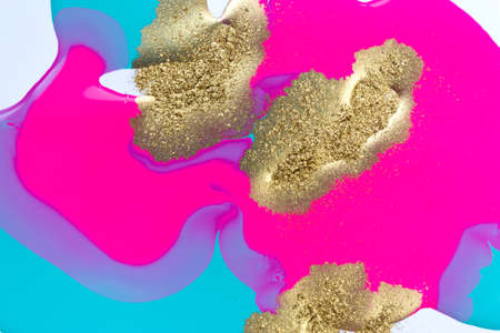Gold yellow dust spots on flow vivid paints background. Abstract print