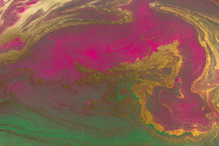 Dark flow paints background. Gold and purple liquid inks.の写真素材