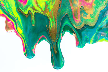 Gold and fluorescent nail polish flowing on white background.の写真素材