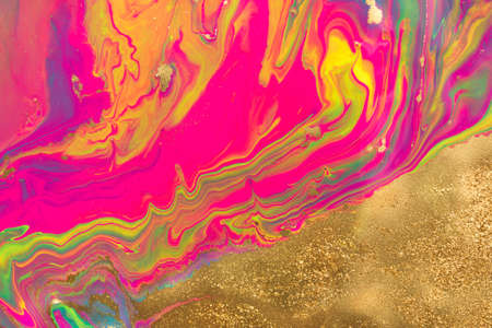 Gold dust spots on liquid fluorescent paints background.の写真素材