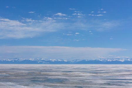 Frozen Lake and Snowy Mountains Winter Landscapeの写真素材