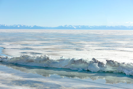 Frozen Lake and Snowy Mountains Winter Landscapeの写真素材