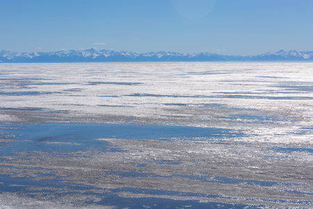 Frozen Lake and Snowy Mountains Winter Landscapeの写真素材