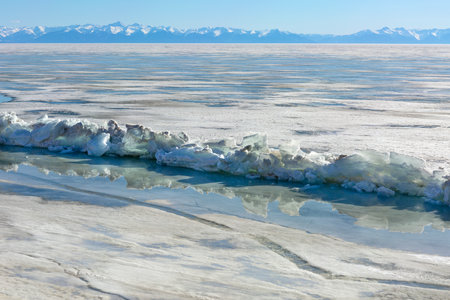 Frozen Lake and Snowy Mountains Winter Landscapeの写真素材
