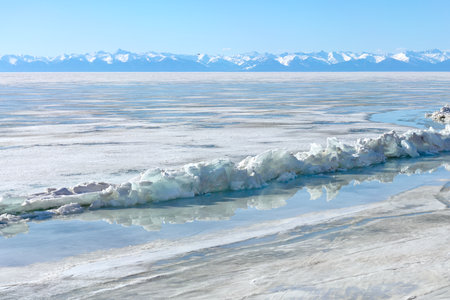Frozen Lake and Snowy Mountains Winter Landscapeの写真素材