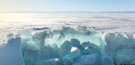 Frozen Lake and Snowy Mountains Winter Landscapeの写真素材